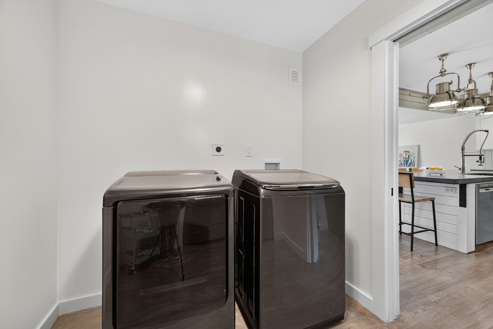 Dedicated utility room with washer and dryer adjoining the kitchen
