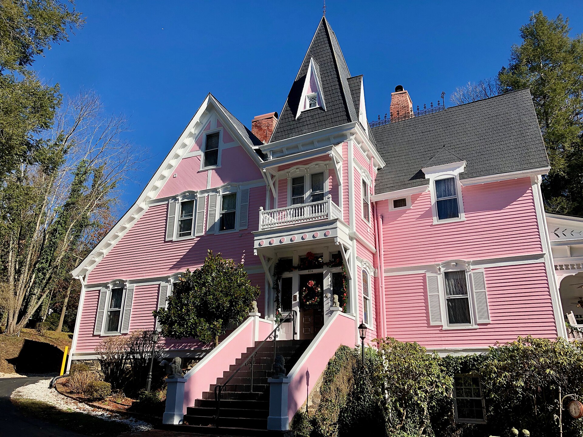 Swannanoa Hill Mansion in Kenilworth — a pink Gothic Revival house with steep gables, a tower and a balcony